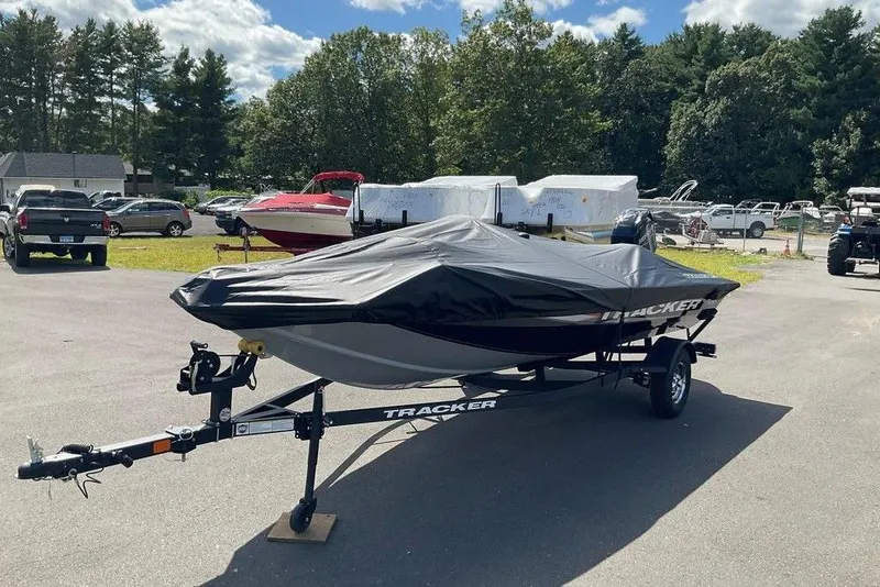 Slide: The Image of 2025 Tracker Pro Team 175 boat with cover on trailer in outdoor lot. - 40