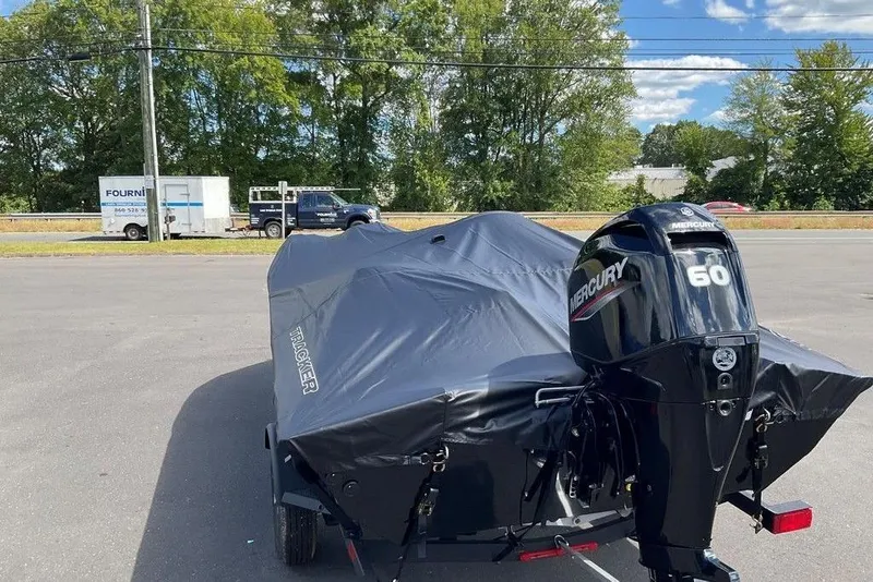 Slide: The Image of 2025 Tracker Pro Team 175 boat with Mercury 60 engine, covered and parked outdoors. - 41