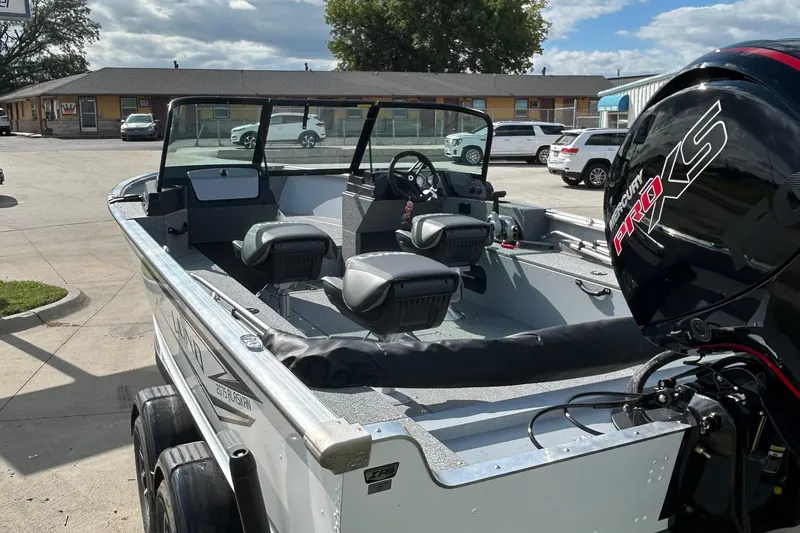 Slide: The Image of 2026 Lund 2075 Alaskan Sport boat with Mercury Pro XS engine in parking lot. - 12