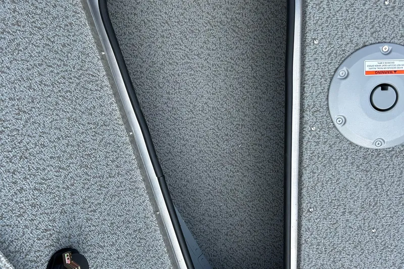 Slide: The Image of Interior view of 2026 Lund 2075 Alaskan Sport boat with gray textured flooring. - 23