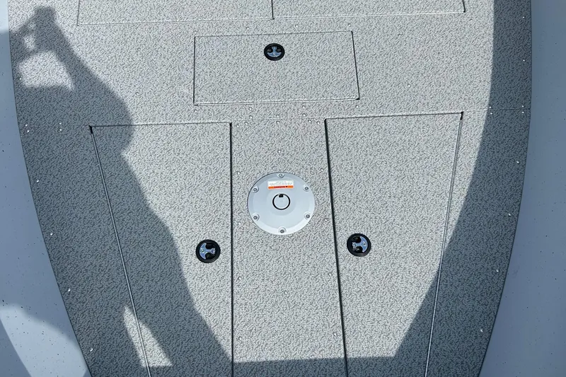 Slide: The Image of 2026 Lund 2075 Alaskan Sport boat deck with storage compartments and shadow. - 32