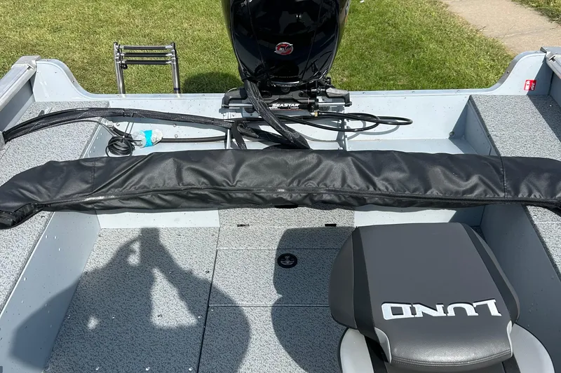 Slide: The Image of 2026 Lund 2075 Alaskan Sport boat interior with motor and seating. - 8