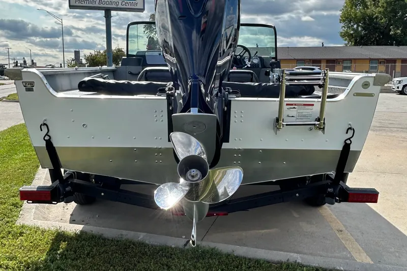 Slide: The Image of 2026 Lund 2075 Alaskan Sport boat rear view with outboard motor and ladder. - 9