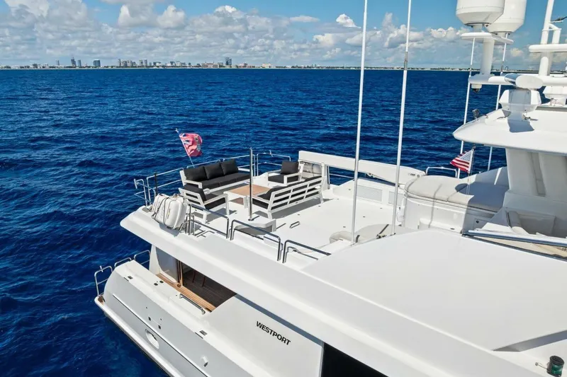 Slide: The Image of Luxurious 2011 Westport yacht cruising on blue ocean with city skyline in background. - 11