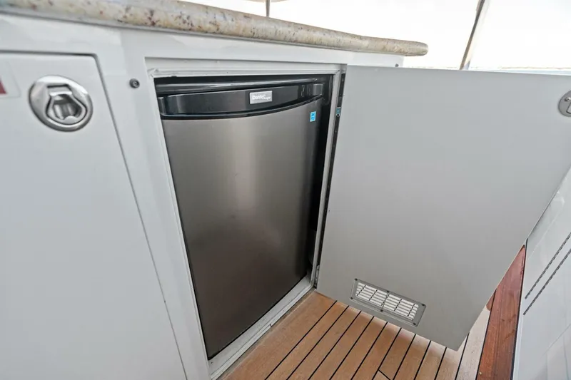 Slide: The Image of Built-in mini fridge on a 2011 Westport yacht with wooden flooring. - 21