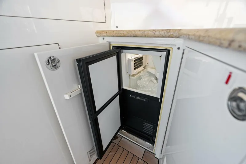 Slide: The Image of Open ice maker in 2011 Westport yacht kitchen with wooden flooring and granite countertop. - 22