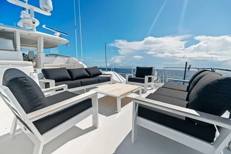 Slide: The Image of Luxurious 2011 Westport yacht deck with elegant seating, ocean view, and clear blue sky. - 24