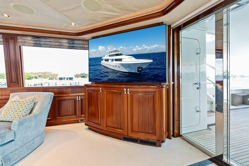 Slide: The Image of Luxurious yacht interior with wooden cabinetry, featuring a Westport 2011 model on a screen. - 37