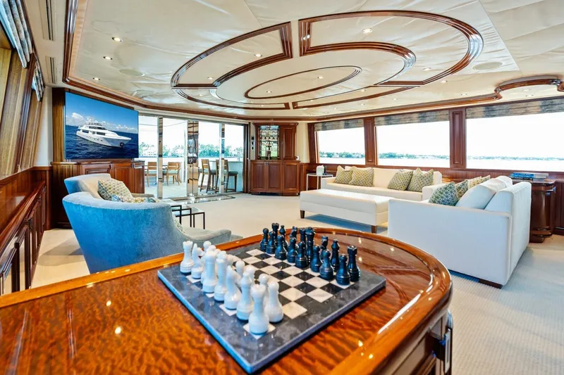 Slide: The Image of Luxurious 2011 Westport yacht interior with elegant seating, chess set, and panoramic windows. - 38