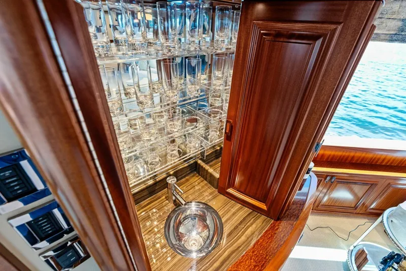 Slide: The Image of Luxurious 2011 Westport yacht interior with elegant wooden cabinetry and glassware display. - 41