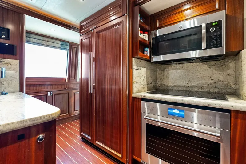 Slide: The Image of Luxurious 2011 Westport yacht kitchen with wood cabinetry, modern appliances, and granite countertops. - 43