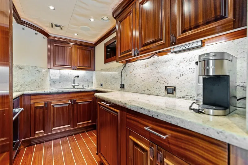 Slide: The Image of Luxurious yacht kitchen with wooden cabinetry, granite countertops, and modern appliances, Westport 2011 model. - 44