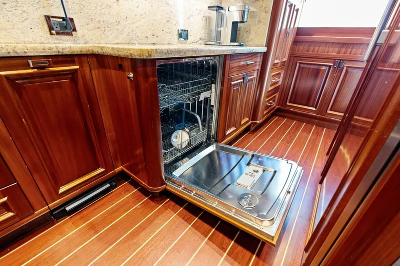 Slide: The Image of Luxurious yacht kitchen with open dishwasher, wooden cabinets, and sleek countertops, Westport 2011 model. - 45