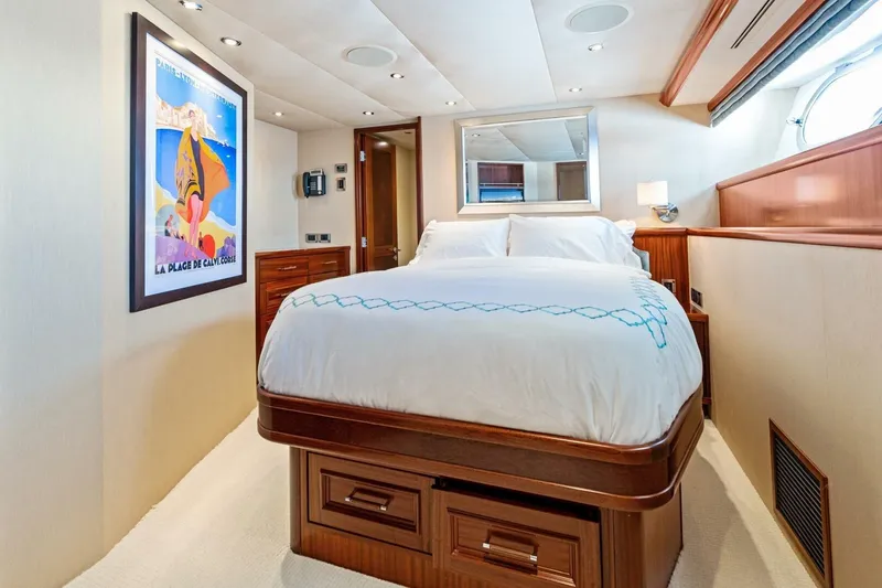 Slide: The Image of Luxurious bedroom interior on 2011 Westport yacht, featuring elegant bedding and stylish artwork. - 52