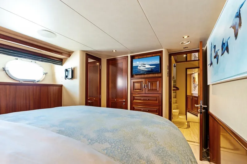 Slide: The Image of Luxurious 2011 Westport yacht bedroom with elegant wood paneling and nautical decor. - 55