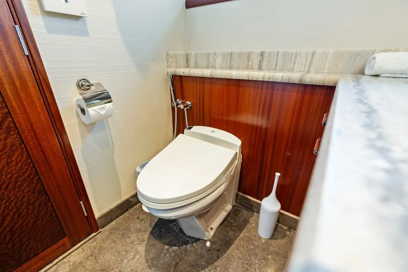 Slide: The Image of Luxurious Westport 2011 yacht bathroom with modern toilet and elegant wood paneling. - 59