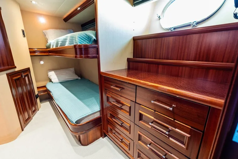 Slide: The Image of Luxurious 2011 Westport yacht cabin with wooden bunk beds and storage drawers. - 61