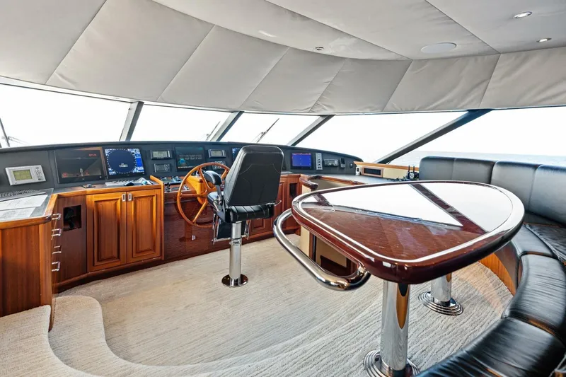 Slide: The Image of Luxurious 2011 Westport yacht helm with wooden accents and modern navigation equipment. - 65