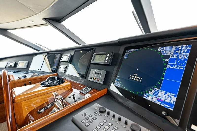 Slide: The Image of Control panel of a 2011 Westport yacht featuring advanced navigation systems and displays. - 69