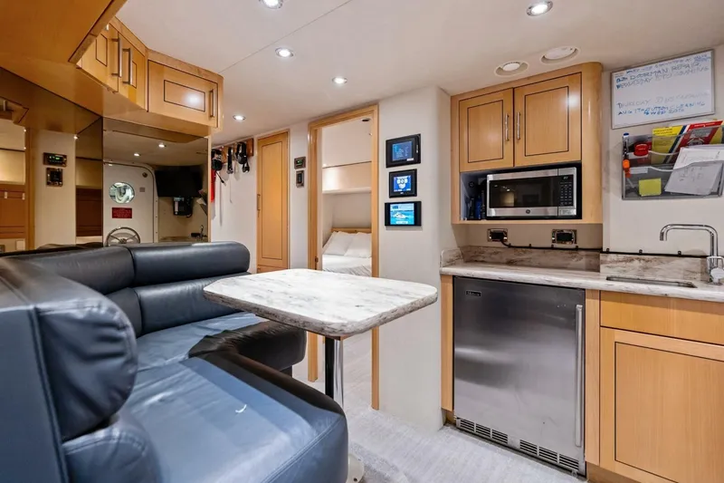 Slide: The Image of Luxurious 2011 Westport yacht interior with modern kitchen, dining area, and cozy sleeping quarters. - 71