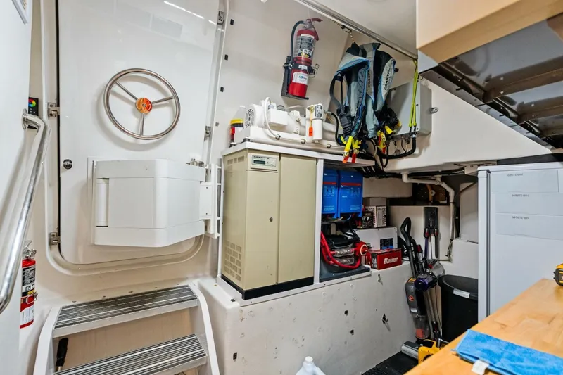 Slide: The Image of Utility room in a 2011 Westport yacht with equipment and safety gear. - 78