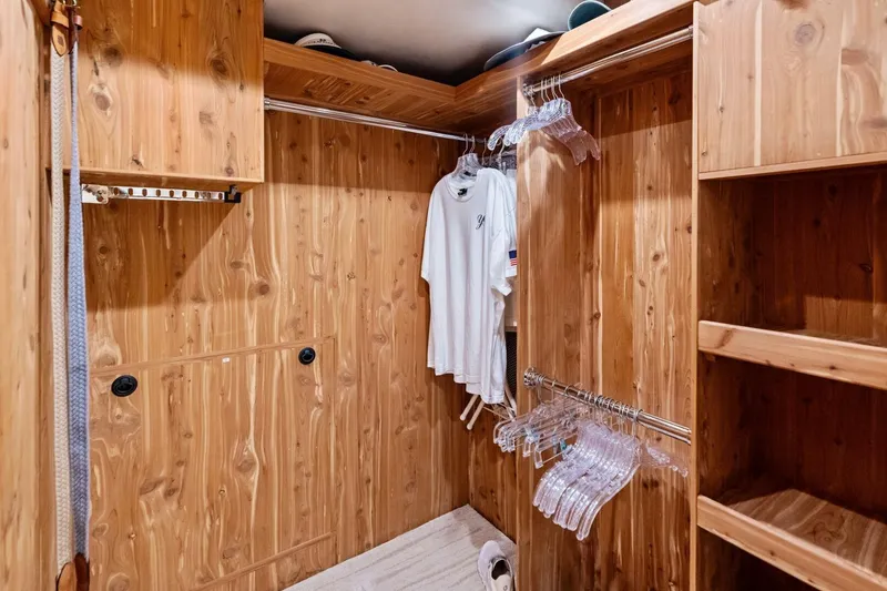 Slide: The Image of Wooden walk-in closet with hangers and shelves in a 2011 Westport model. - 82