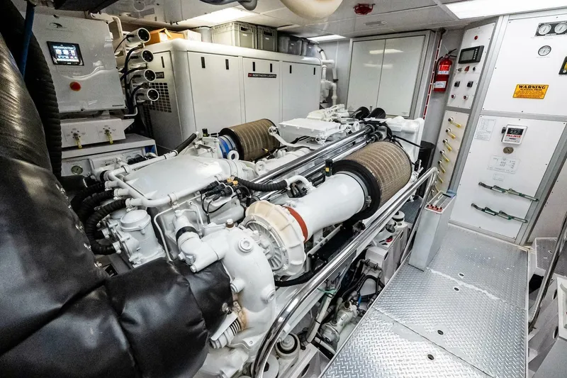 Slide: The Image of Engine room of a 2011 Westport yacht, featuring advanced machinery and control panels. - 84