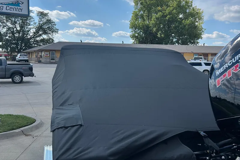 Slide: The Image of Covered 2026 Lund 1875 Crossover XS boat with Mercury Pro engine in parking lot. - 10