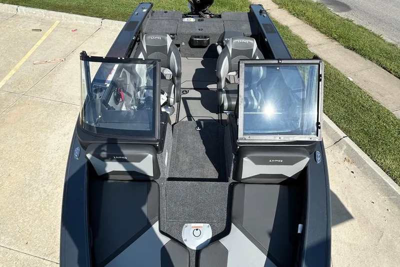 Slide: The Image of 2026 Lund 1875 Crossover XS boat, interior view with seating and windshield. - 12