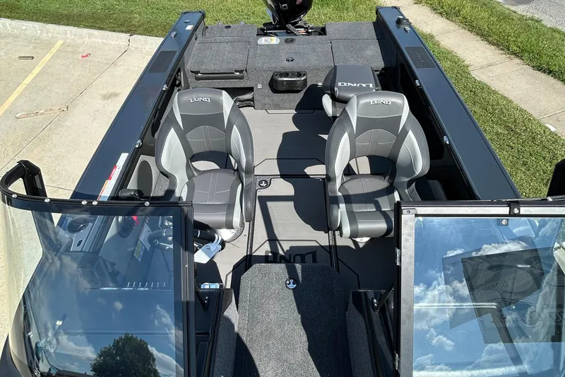 Slide: The Image of 2026 Lund 1875 Crossover XS boat interior with gray seating and open deck layout. - 13