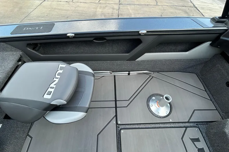 Slide: The Image of 2026 Lund 1875 Crossover XS boat interior with seating and storage compartments. - 18