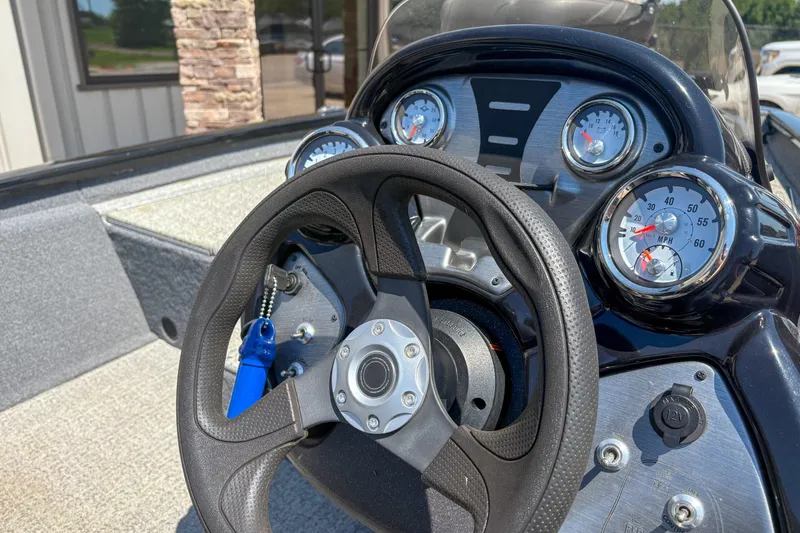 Slide: The Image of 2021 Tracker Pro Team 175 TXW boat dashboard with steering wheel and gauges. - 10