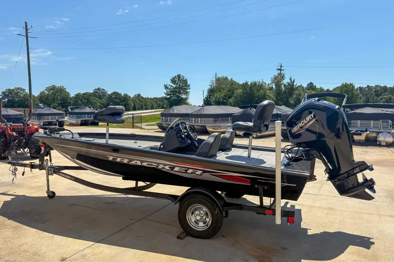 Slide: The Image of 2021 Tracker Pro Team 175 TXW boat with Mercury engine on trailer, outdoors. - 4