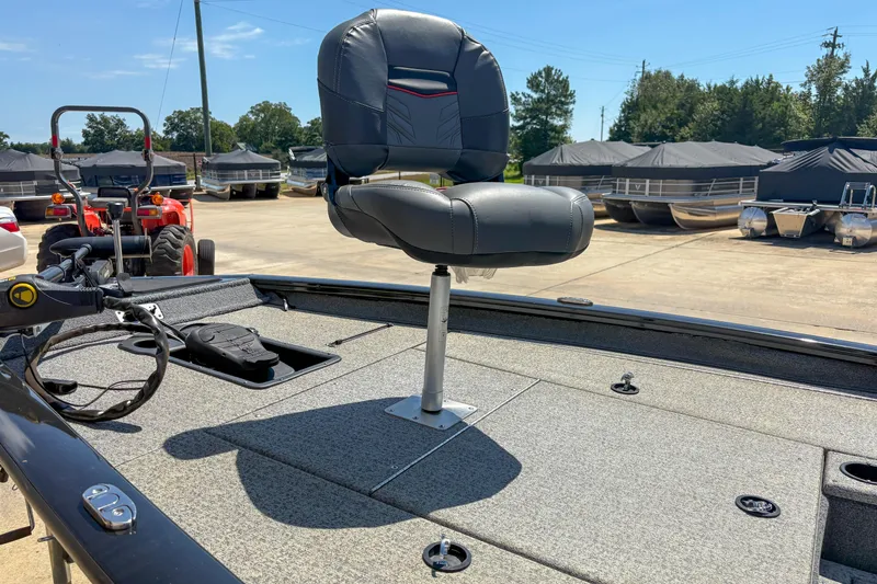 Slide: The Image of 2021 Tracker Pro Team 175 TXW boat with elevated seat on deck, parked outdoors. - 6