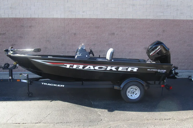 The Image of 2026 Tracker Super Guide V-16 fishing boat on trailer, side view. - 1