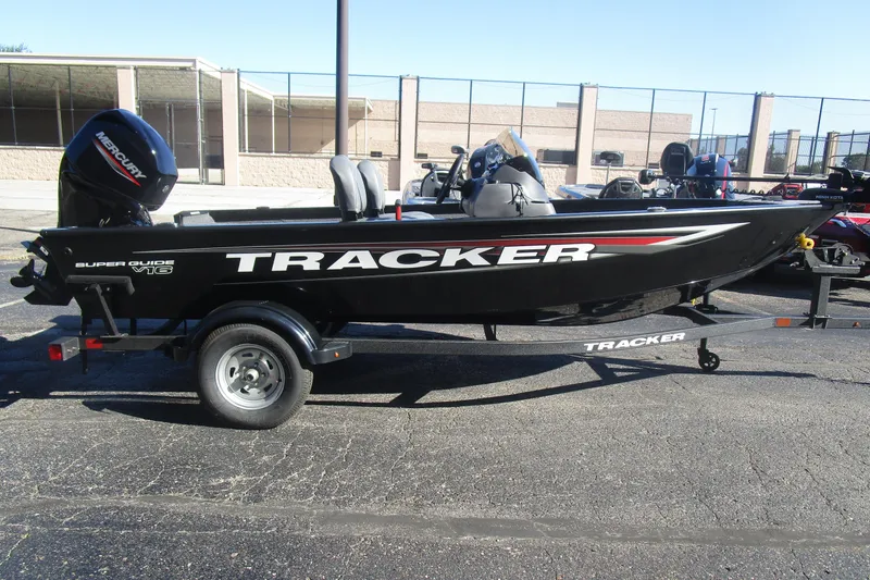 Slide: The Image of 2026 Tracker Super Guide V-16 boat on trailer, parked outdoors. - 11