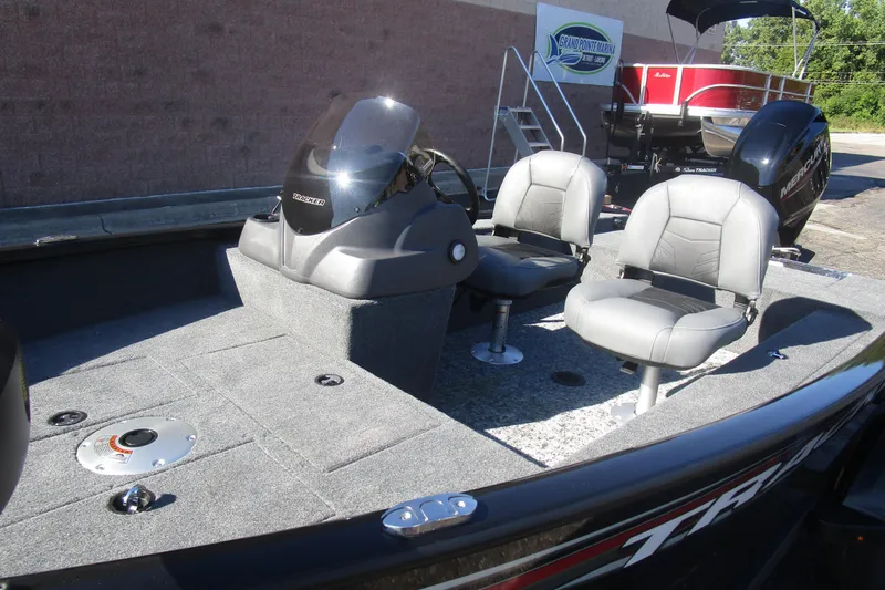 Slide: The Image of 2026 Tracker Super Guide V-16 boat interior with two seats and steering console. - 3