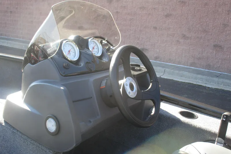 Slide: The Image of 2026 Tracker Super Guide V-16 boat dashboard with steering wheel and gauges. - 7