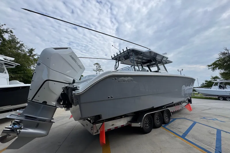 Slide: The Image of 2026 Invincible 40 Catamaran on trailer, featuring powerful Mercury outboard engines. - 12