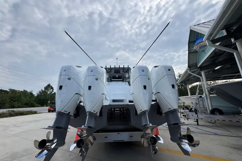 Slide: The Image of 2026 Invincible 40 Catamaran with four powerful outboard engines, docked under a cloudy sky. - 15