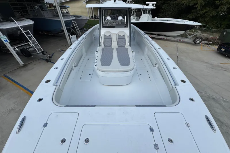 Slide: The Image of 2026 Invincible 40 Catamaran with spacious deck and seating, docked in a marina. - 18