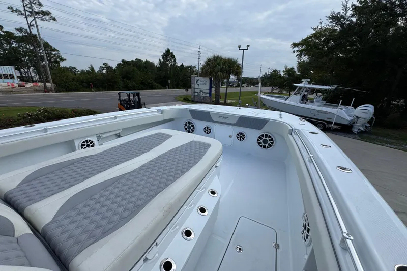 Slide: The Image of Invincible 40 Catamaran 2026 with spacious deck and seating, parked outdoors. - 23