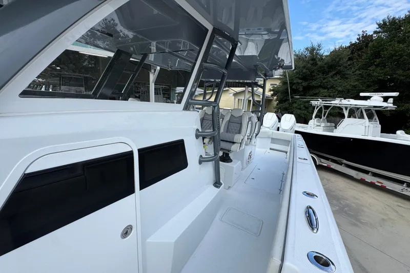 Slide: The Image of 2026 Invincible 40 Catamaran with sleek design and modern seating, docked outdoors. - 24