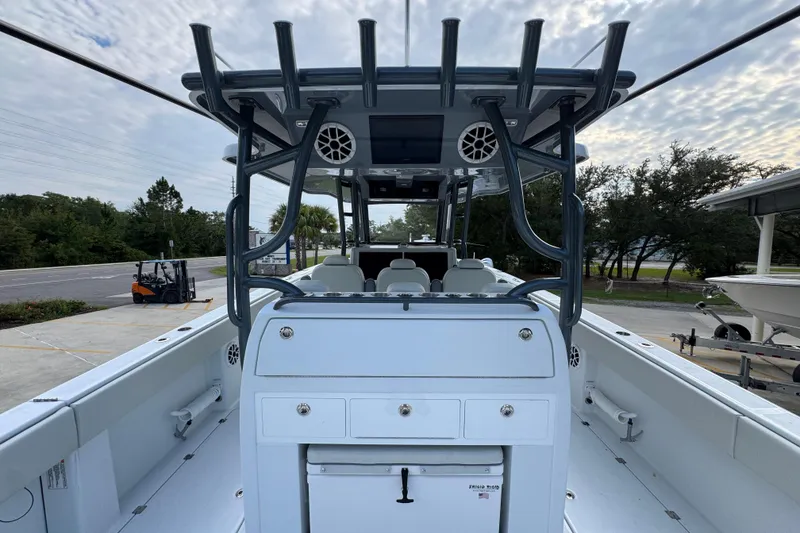 Slide: The Image of 2026 Invincible 40 Catamaran interior with helm station and seating, under a cloudy sky. - 36