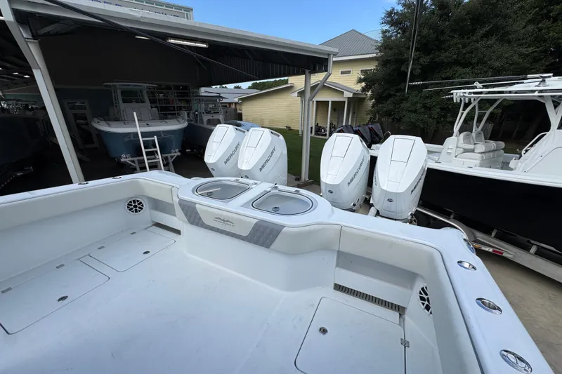 Slide: The Image of 2026 Invincible 40 Catamaran with powerful Mercury outboard engines in a boatyard setting. - 38