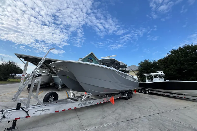 Slide: The Image of 2026 Invincible 40 Catamaran on trailer under blue sky, ready for launch. - 4