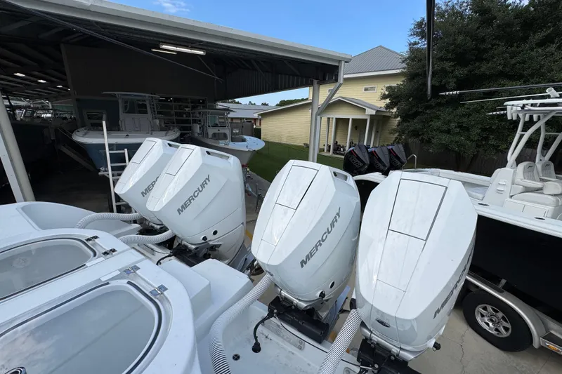 Slide: The Image of 2026 Invincible 40 Catamaran with Mercury outboard engines in a boat storage area. - 40