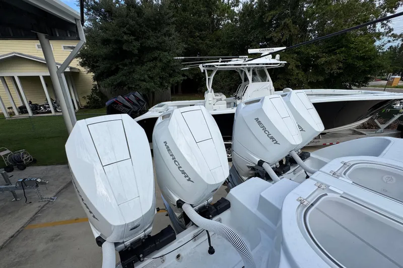 Slide: The Image of 2026 Invincible 40 Catamaran with multiple Mercury outboard engines, parked outdoors. - 41