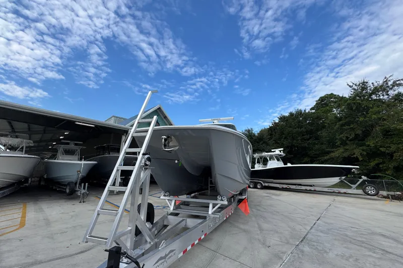 Slide: The Image of 2026 Invincible 40 Catamaran on trailer under blue sky, surrounded by other boats. - 5
