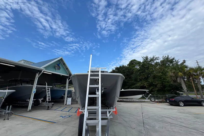 Slide: The Image of Invincible 40 Catamaran 2026 on trailer, parked outdoors under a partly cloudy sky. - 6